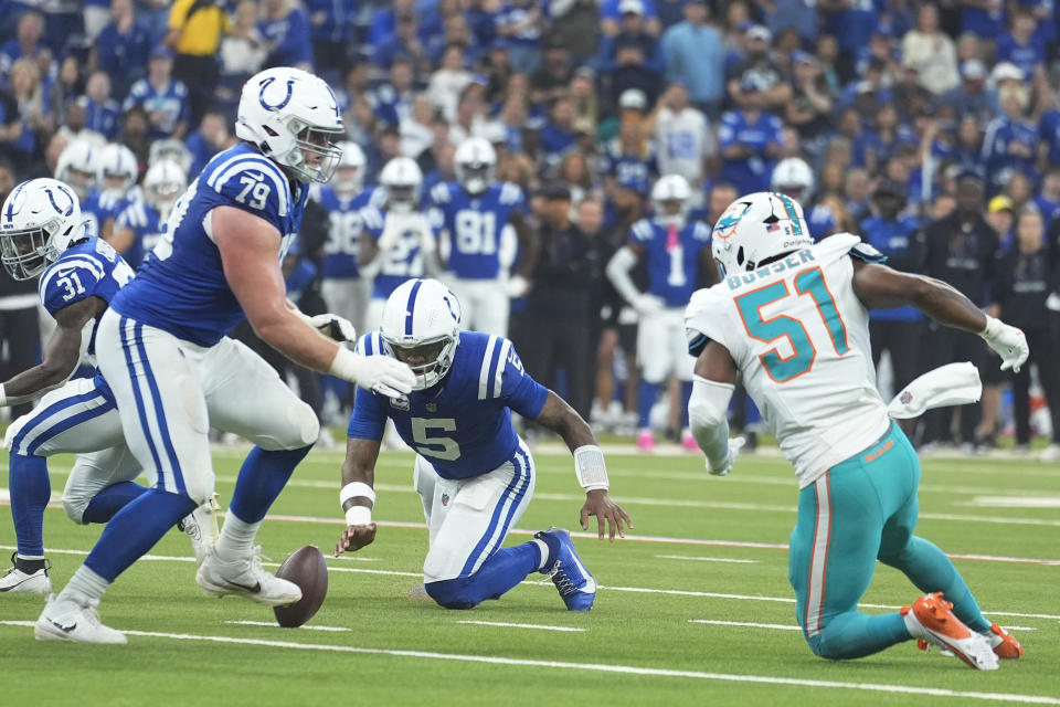 Indianapolis Colts quarterback Anthony Richardson (5) fumbles during the first half of an NFL football game against the Miami Dolphins, Sunday, Oct. 20, 2024, in Indianapolis. (AP Photo/Michael Conroy)