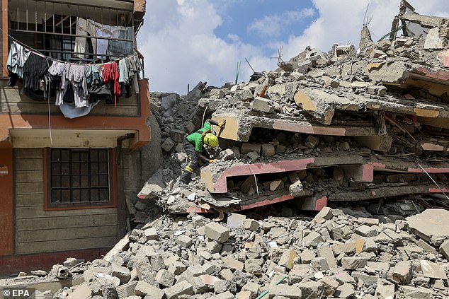 A Kenyan rescuer inspects the rubble during a search and rescue mission