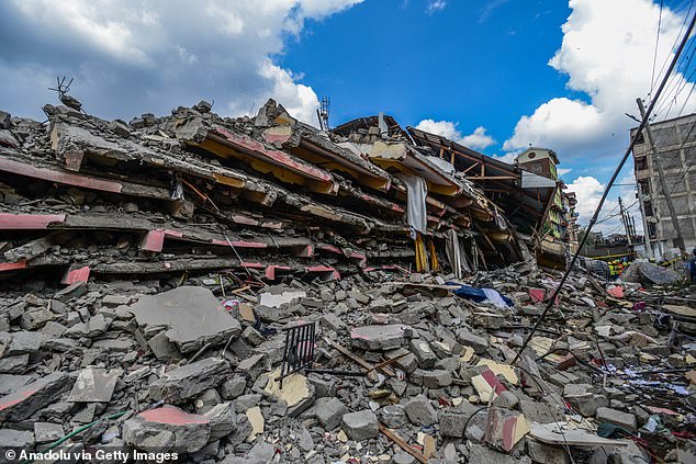 Kenyan security forces take precautions among the remains of the building where search and rescue operations took place