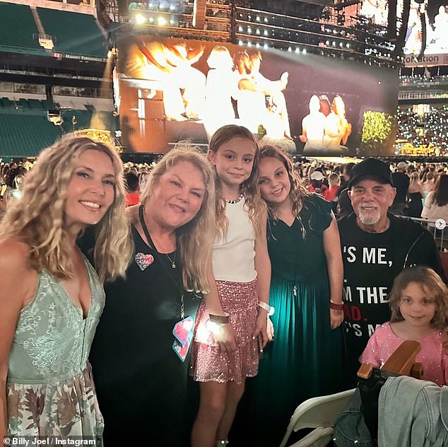 Joel and his family also joined Taylor's mother, Andrea, 66, (second left) in the crowd for the show and shared another sweet photo.