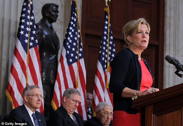 Susan Ford Bales speaking at the United States Capitol at the dedication ceremony for her father's statue in May 2011. Seated behind her are then-Majority Leader Harry Reid, Minority Leader Mitch McConnell and Former Secretary of State Henry Kissinger.