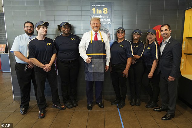 Workers smiled as they posed with Trump at McDonald's restaurant