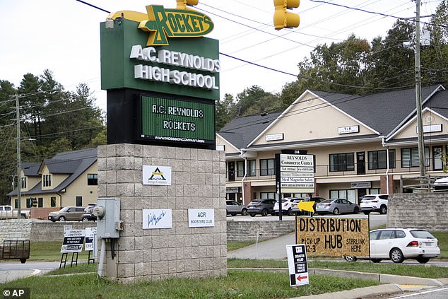 Signs are seen at a FEMA Disaster Recovery Center at AC Reynolds High School in Asheville.