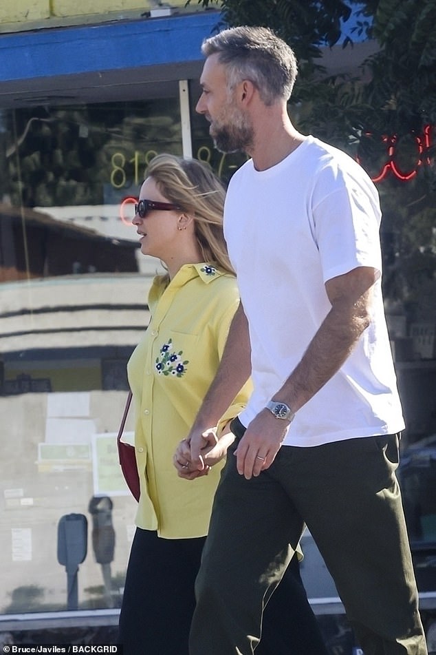 The couple held hands as they walked together.