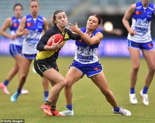 McCarthy (pictured with the ball while playing for Richmond this year) says homophobic, sexist and racist comments online must end