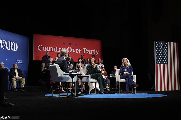 Democratic presidential candidate Vice President Kamala Harris, center, with former Congresswoman Liz Cheney, right, and moderator Charlie Sykes, left, together on stage during a town hall at the Sharon Lynne Center for the Arts Wilson in Brookfield, Wisconsin.