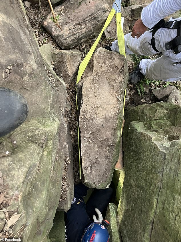 The woman was safely freed after rescuers moved a 500kg rock.