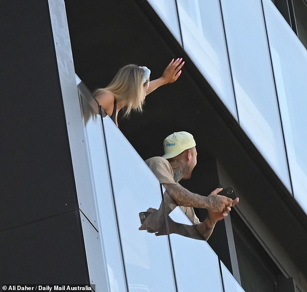 Jamie, with her blonde locks pulled back under a stylish headband, beamed as she pointed in the Queen's direction, while Dave, wearing a backwards cap and showing off his inked arms, filmed the moment on his phone.