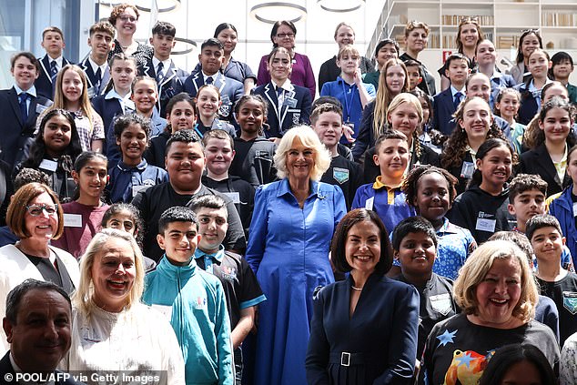 The Queen posed with students, authors and book club members after presenting certificates to past entrants to the Queen's Commonwealth Essay Competition, an annual competition organized by the Royal Commonwealth Society.