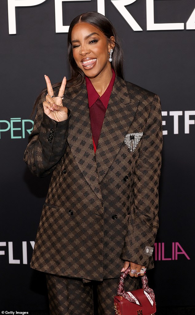 The 43-year-old singer and actress wore a brown and black printed Amiri suit over a burgundy shirt.