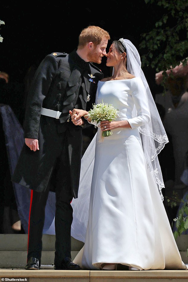 Meghan Markle's wedding dress was designed by Claire Waight Keller. Above: Meghan kissing Prince Harry outside St George's Chapel on their wedding day, May 2018