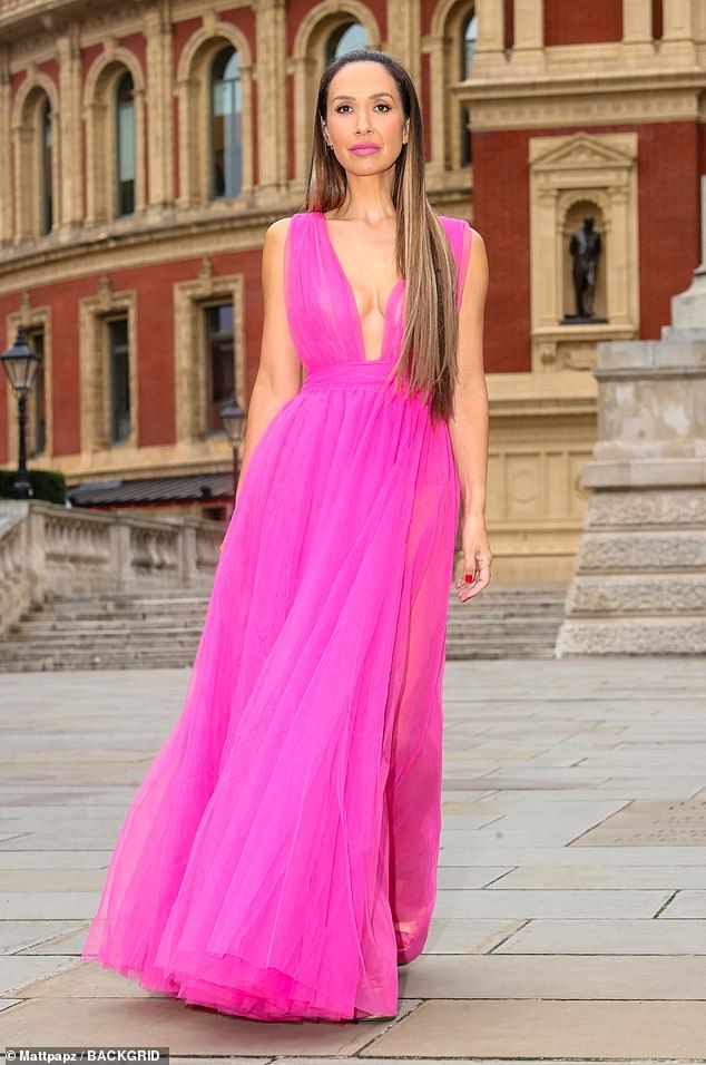 The radio presenter, 46, turned heads when she went braless in a bright pink Barbie dress that featured a plunging neckline.