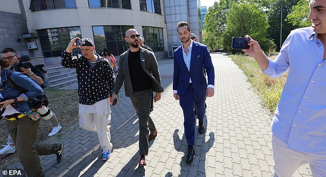 Former professional kickboxer and social media influencer Andrew Tate (CL) and his brother Tristan (CR), assisted by their bodyguards and surrounded by journalists, leave the building after a pre-trial hearing to lift the asset seizure held in the Bucharest Court. in Bucharest, Romania, September 23, 2024