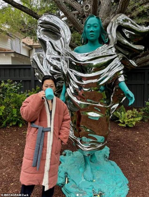 Priscilla Chan poses in front of a statue of herself commissioned by her billionaire husband Mark Zuckerberg