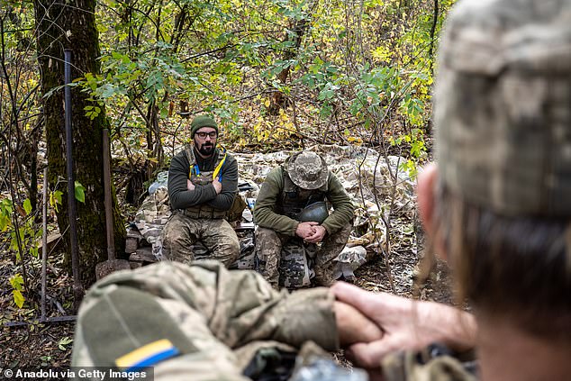 A group of Ukrainian soldiers rest after firing a howitzer at Russian positions in Donetsk Oblast, Ukraine, on October 21, 2024.