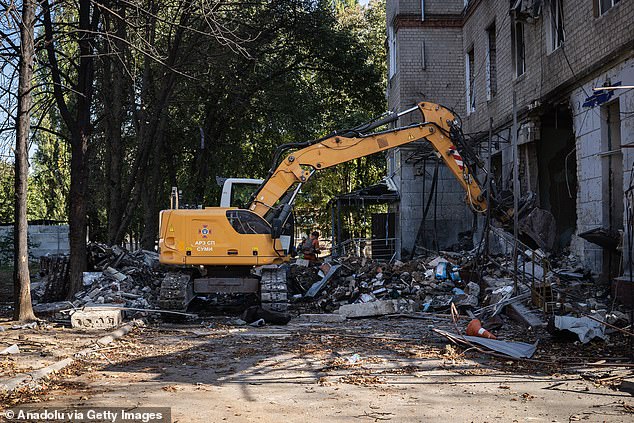 Heavy construction equipment is used to remove debris after a double attack by Russian forces on a hospital in Sumy, Ukraine, September 28, 2024.