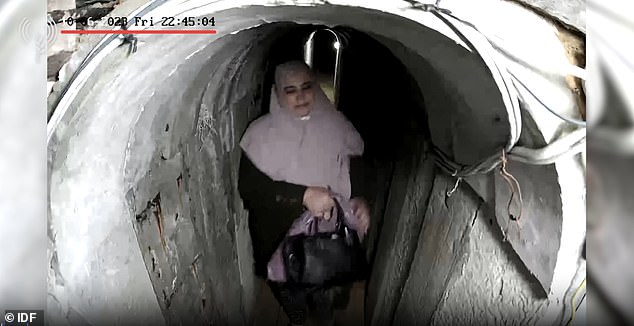 This is the moment the wife of Hamas leader Yahya Sinwar is seen apparently holding a bag of $32,000 in the tunnel leading to his secret lair.