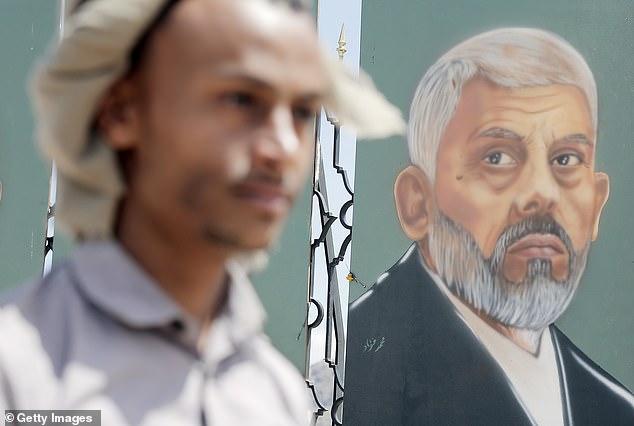 A Yemeni man looks at a piece of art depicting Hamas Political Bureau chief Yahya Sinwar.