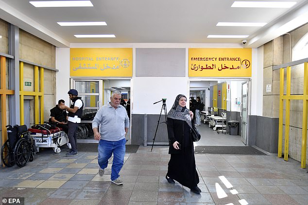 A photograph taken during a press tour of the hospital shows people near the entrance.