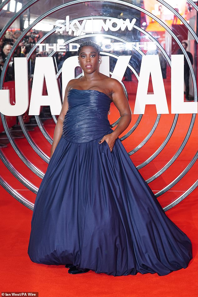 Lashana accessorized with several jeweled earrings, while silver threads were intricately sewn into her short hair.