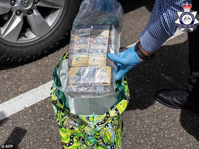 A search of another vehicle led to the discovery of around $100,000 in cash (pictured), prepaid SIM cards, a phone and an iPad.