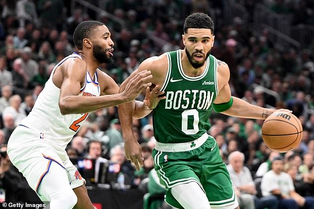 Boston Celtics' Jayson Tatum drives in Knicks forward Mikal Bridges on Tuesday