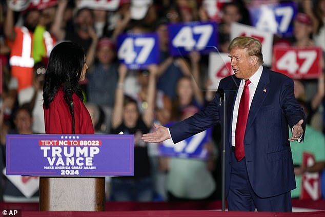 Trump watches in shock as Gabbard announces her move to the Republican Party at his rally in North Carolina.