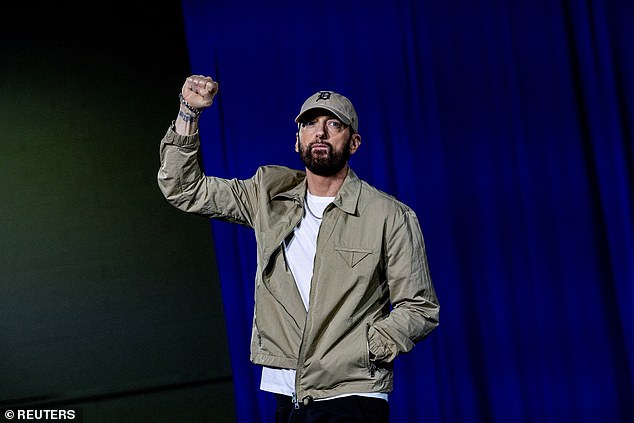 Detroit-based rapper Eminem took his first hit while taking the stage to introduce former President Barack Obama at a rally Tuesday night in support of Democratic candidate Vice President Kamala Harris.