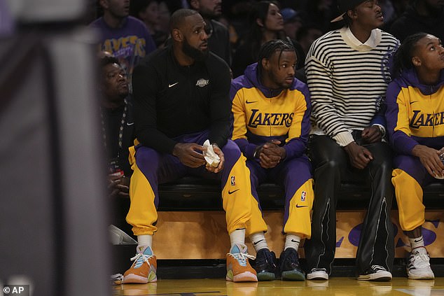 LeBron James and his son Bronny watch their Lakers teammates play against the Timberwolves