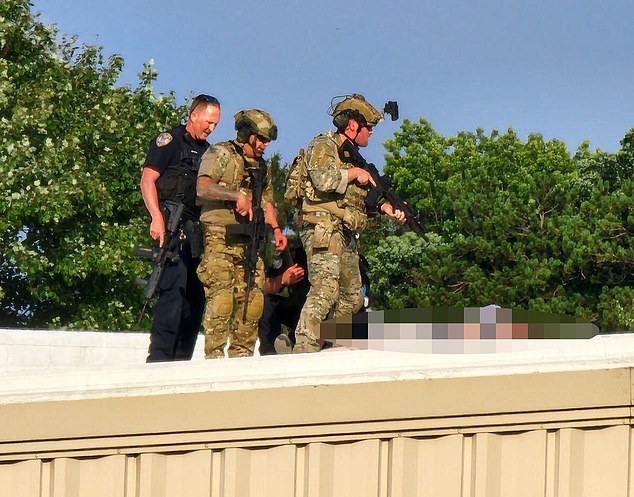 It was especially worrying that a building that had been widely considered a security threat was unsecured, allowing gunman Thomas Matthew Crooks, 20, to gain access. In the photo, Secret Service agents stand next to the body of the possible murderer after the shooting.