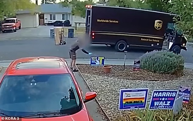 The UPS driver could be seen taping a dozen small Trump flags in the woman's yard.