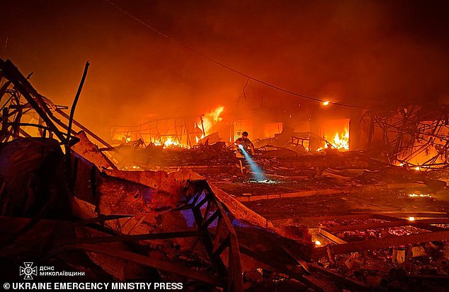 A rescuer searches for survivors after a Russian attack in Mykolaiv, Ukraine.