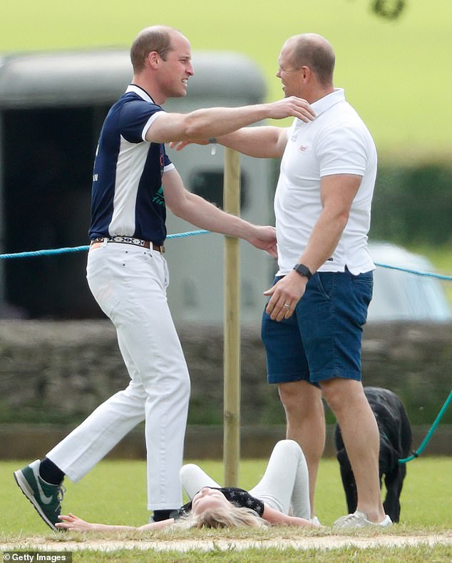 Prince William and Mike Tindall are pictured hugging at a polo match in 2017.