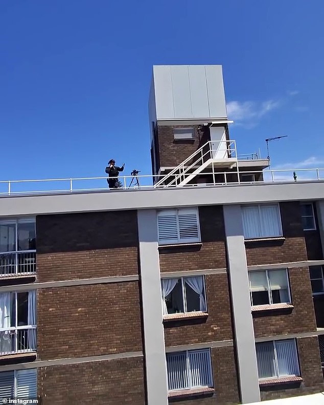 Pollard filmed several interactions with police, including one involving a police sniper (pictured) standing on the rooftop of an apartment across from Pollard's unit.