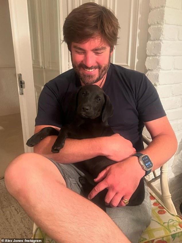 In another snap, Alex gave her followers a glimpse of her husband Charlie Thomson, who smiled as he played with the family's new black Labrador puppy.