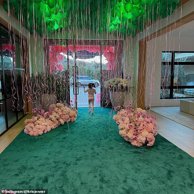 One of the children walked through the driveway of Kim's house displaying the balloons and flowers.