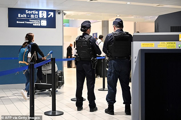 Police stand at a customs checkpoint at Roissy-Charles de Gaulle airport, on the northern outskirts of Paris, on October 18, 2024.