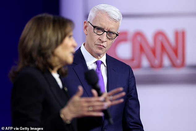 CNN's Anderson Cooper (center) watches Vice President Kamala Harris (left) answer a question during a town hall event in suburban Philadelphia Wednesday night aimed at undecided voters.