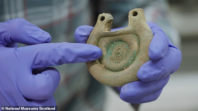 One of the Peebles Hoard objects seen being examined by an expert