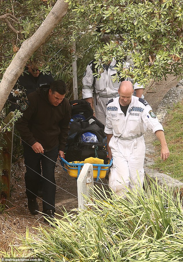 Emergency services recover Thijssen's body after he was seen trapped between rocks beneath a clifftop park, two days after he murdered Ms James.