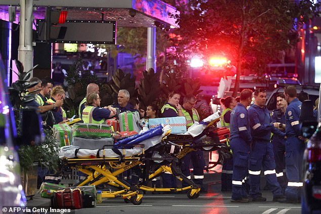 Paramedics are seen with stretchers outside Westfield Bondi Junction shopping center after a stabbing incident in Sydney on April 13, 2024.