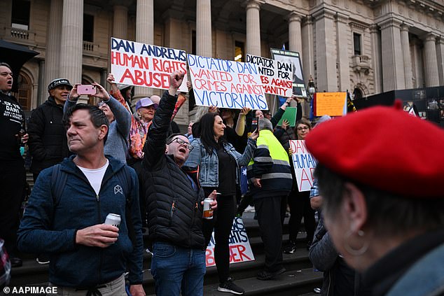 People gather on the steps of Victoria's Parliament to celebrate Andrews' resignation as premier last year.