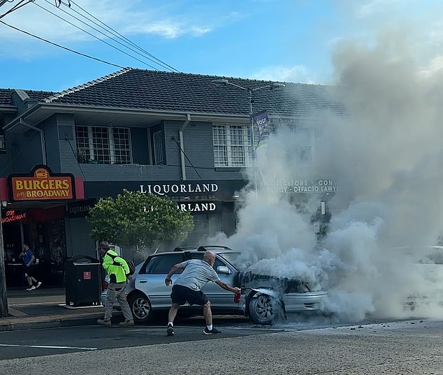 A heroic man runs into hell with a small fire extinguisher to try to put out the flames without much luck.