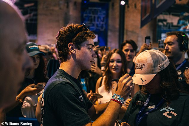 F1's new star Colapinto signs a Williams fan's cap at the team's pop-up store in Austin