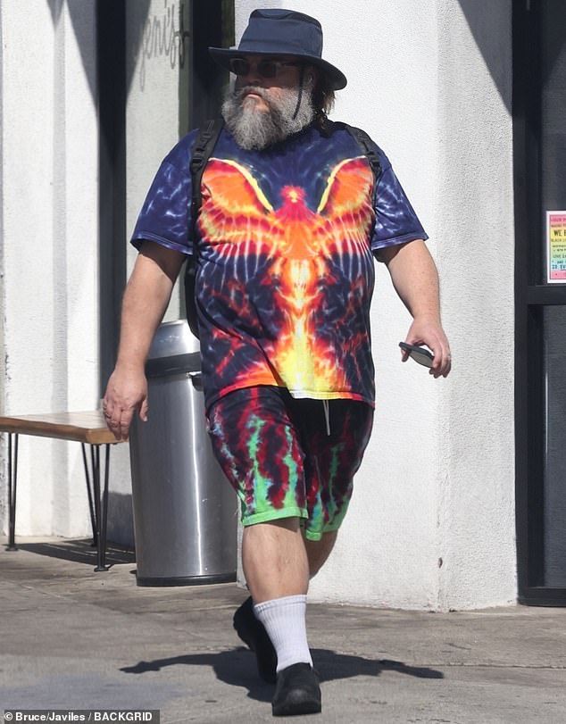 It's actor and comedian Jack Black, 55, who was wearing a short-sleeved blue shirt that had an orange bird with wings printed on the front and green flame shorts.