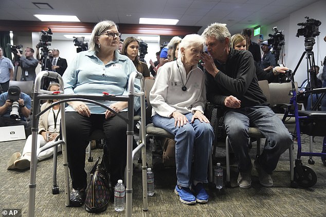 Family members of victim Kitty Menendez spoke among themselves before the district attorney's announcement Thursday. In the photo: Arnold VanderMolen whispering in the ear of Kitty's sister, Joan VanderMolen, 92 years old.