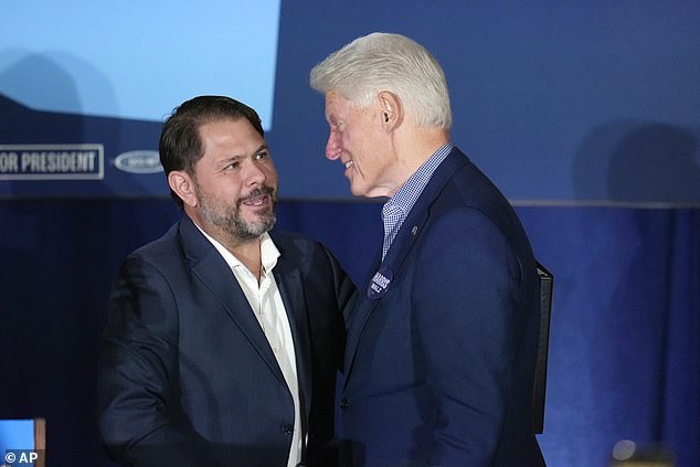 Former President Bill Clinton (right) speaks briefly with Arizona Democratic Senate candidate Rep. Ruben Gallego as Clinton takes the stage at a campaign event in support of Vice President Kamala Harris, the Democratic presidential candidate.