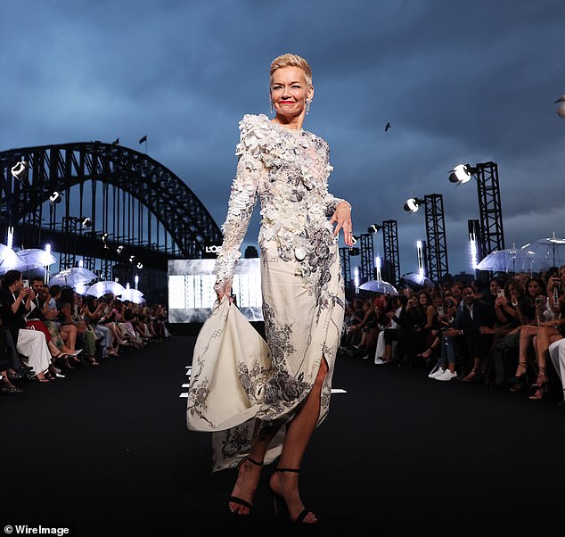 Working the angles for the crowd, Jessica put on a leggy display in a stunning white dress embellished with black patterns and floral sequins and rhinestones.