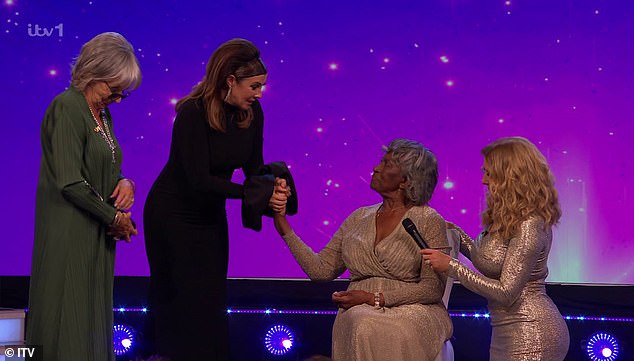 The actress and singer, 48, was visibly emotional as she presented former midwife Agnes Nisbett, 87, with the Community Hero honor during the event.