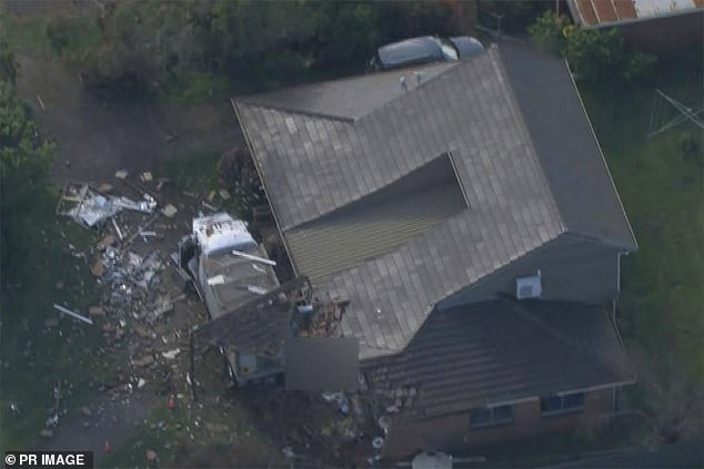 The impact left broken glass and debris scattered across the yard.